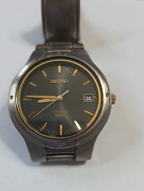Seiko Titanium Watch with Black Dial and Gold Accents